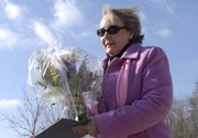 Carol Brown delivers flowers for the Habitat for Humanity Women Build Valentine's Day Fundraiser on Tuesday in Lawrence. Brown is the recipient of a house that will be built with the help of money through the fundraiser.