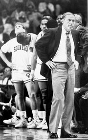 Oklahoma coach Billy Tubbs, right, and his Sooners hang their heads late in their 83-79 championship game loss to the Jayhawks.