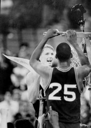 KU's Chris Piper and Danny Manning (25) cut down the nets after a 69-54 victory over Kansas State in Detroit secured a trip to the FInal Four.