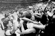 Kansas' Jeff Gueldner, right, is at the center of this hug scrum as time ran out on the 1988 national title game.