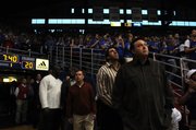 Mike Maddox, right, and Mark Randall along with other members of the 1988 National Championship team watch a highlight video from the year before being introduced to the Allen Fieldhouse crowd during halftime Saturday, Feb. 16, 2008.