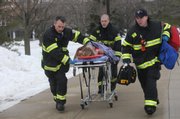 Rescue workers, including Travis Karr, a Free State High School graduate, center, evacuate a victim of a shooting Thursday at Northern Illinois University in DeKalb, Ill. Travis Karr is the son of Jerry Karr, a longtime Lawrence firefighter who retired in 2006.