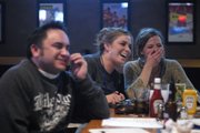 Aaron Hoare, at left, Whitney Gallagher and Erin Leary, of the Johnny's Tavern team, react to Leary's answer to a quiz question Sunday during the sixth annual Irish Pub Quiz at Zig & Mac's, 1540 Wakarusa Drive.