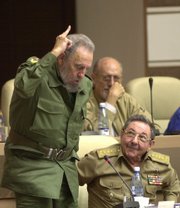 Cuba's President Fidel Castro, left, votes in favor to the modification on the Cuban Constitution, as his brother, Defense Minister Raul Castro, looks at him during an extraordinary National Assembly session in Havana, in this June 26, 2002 file photo. Ailing leader Fidel Castro resigned as Cuba's president early Tuesday Feb. 19, 2008, after nearly a half-century in power, saying he will not accept a new term when the newly elected parliament meets on Sunday.