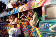 Former University of Oregon wrestling coach Ron Finley, front, waits Feb. 16 with members of the team to ride on the latest incarnation of author Ken Kesey's psychedelic bus, Further. Kesey's spirit has joined efforts to save the sport from being dropped by the university.