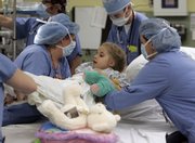 Eight-year-old Sarah Dickman is readied for kidney transplant surgery Wednesday at Children's Healthcare of Atlanta at Egleston. Laura Bolan saw the flier and decided to donated one of her kidneys to Sarah, who was born with the genetic disease juvenile nephronophthisis, which slowly destroys the kidneys. Without treatment, it can kill a child before the age of 15.