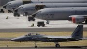 An F-15 rolls along the runway while KC-135's are seen on the tarmac at the Oregon Air National base in Portland, Ore., in this Aug. 26, 2005, file photo. A $40 billion contract to replace the Air Force's aging fleet of aerial refueling tankers will be awarded as early as next week to Boeing, or a team made up of Airbus' parent and Northrop Grumman.