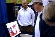 Lawrence architect Daniel Boardman, left, shows John, center, and Marlene Dillard, right, images of his work Sunday, Feb. 24, 2008 during the Lawrence Home Builders Association Home Show at First Serve Tennis Center, 5200 Clinton Parkway.