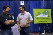 Grant Lechtenberg, left, and Tim Stultz, both of Lawrence, talk while manning the Lawrence Home Builders Association booth Sunday, Feb. 24, 2008 at the Lawrence Home Show at First Serve Tennis, 5200 Clinton Parkway.