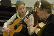 Sandra Flessau, a student of Andreas van Zoest, at right, both of Lawrence's sister city, Eutin Germany, performed for students Tuesday at Southwest Junior High School, 2511 Inverness Drive.