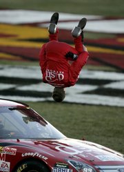 NASCAR driver Carl Edwards does a back flip to celebrate winning the UAW-Dodge 400. Edwards won Sunday in Las Vegas, his second checkered flag in a week.