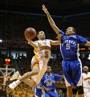 Tennessee's Chris Lofton, left, shoots over Kentucky's Derrick Jasper during the first half. UT won, 63-60, on Sunday in Knoxville, Tenn.