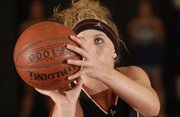 Lawrence High junior Taylor Bird aims a free throw late in the Lions' season-opening victory against Washburn Rural, one of four opponents from LHS's regular-season schedule that will appear in this week's Class 6A state tournament in Emporia.