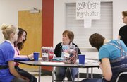 Lee Ann Duver, center, of the League of Women Voters, helps register high school students to vote Sunday, March 2, 2008 during the Lawrence High School Young Democrat's Promote the Vote at LHS.