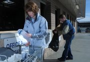 Lawrence residents Debbie Galbraith and Joel Wasson make their way down the line depositing their recyclables Tuesday at the Wal-Mart Recycling Center, 3300 Iowa. The city of Lawrence offers many resources for those who wish to recycle.