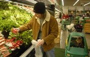 Shopping Friday at Checkers, 2300 La., Dana Lattin and her daughter Sylvia 4, look for vegetables at a good price. As food costs increase, many families are trying to maximize their dollars at the grocery store.