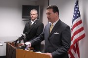Douglas County Sheriff Ken McGovern, left, and Douglas County District Attorney Charles Branson announce first-degree murder charges Tuesday against Major C. Edwards and Durell A. Jones in the shooting death of Anthony "Clacc" Vital.