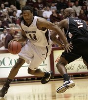 Southern Illinois' Randal Falker drives around Oklahoma State's Marcus Dove. SIU eliminated OSU from the NIT on Tuesday in Carbondale, Ill.