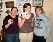 From left are Melissa, Emily and Nicole McIntire. Melissa and Emily are selling a corn flake shaped like the state of Illinois on eBay, and bids have surpassed $1,000.