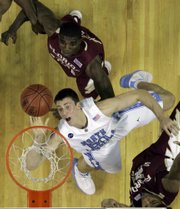 Carolina's Tyler Hansbrough shoots between a pair of Florida State defenders in the Tar Heels' ACC tournament opener.