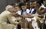 North Carolina coach Roy Williams visits with the Tar Heels during their 82-70 victory over Florida State in the quarterfinals of the ACC tournament.