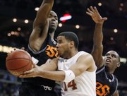 Texas's D.J. Augustin (14) wraps a pass around Oklahoma State's Marcus Dove in the Big 12 tournament quarterfinals.