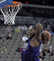 Kansas State forward Bill Walker prepares to dunk during Wednesday's practice for the NCAA Midwest Regional basketball tournament in Omaha, Neb. Kansas State plays Southern California in the opening round at 6:10 tonight.