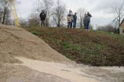 Residents watch water seep through recently placed gravel against a levee on the Black River in Poplar Bluff, Mo. Much of Missouri is threatened with flooding after a slow-moving storm system dumped up to a foot of rain in the nation's midsection.