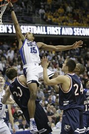 Duke guard Gerald Henderson shoots past Belmont's Matthew Dotson (30) and Justin Hare (24) and scores giving Duke a 71-70 victory in a first round NCAA West Regional basketball game, Thursday March 20, 2008, in Washington.