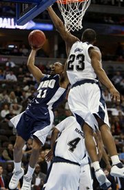 Oral Roberts guard Adam Liberty, back left, goes up for a shot over Pittsburgh guard Ronald Ramon, back right, as forward Sam Young (23) goes up to defend during the second half of Pittsburgh's 82-63 victory in a first-round NCAA men's basketball tournament South Regional game in Denver on Thursday, March 20, 2008.