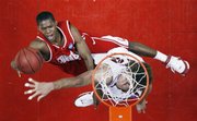 Cornell's Louis Dale, left, moves around the block for a layup against Stanford's Robin Lopez during the second half of a first-round game at the NCAA men's basketball tournament South Regional on Thursday, March 20, 2008, in Anaheim, Calif.