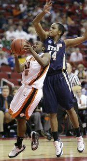 Oklahoma State's Andrea Riley, left, drives past Tennessee State's Siarre Evans. Riley scored 26 points in OSU's victory Saturday in Des Moines, Iowa.