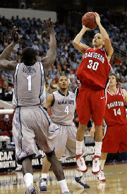 Davidson's Stephen Curry (30) shoots over Georgetown's Vernon Macklin (1) as Chris Wright (4) and Davidson's Max Paulhus Gosselin (14) look on in the second half of a second-round NCAA Midwest Regional basketball game in Raleigh, N.C., Sunday, March 23, 2008.