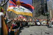 Tsering Dhondup, left, joins other protesters near the United Nations on Saturday in New York. The leading communist Chinese newspaper called Saturday on the government to "resolutely crush" demonstrations in Tibet against Chinese rule.