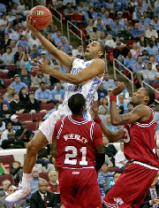 North Carolina's Wayne Ellington drives to the basket over Arkansas' Patrick Beverley (21) and Sonny Weems in the first half of a second-round NCAA East Regional basketball game in Raleigh, N.C., Sunday, March 23, 2008.