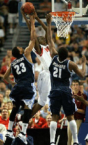 Western Kentucky's Jeremy Evans (4) goes to the basket while being guarded by San Diego's De'Jon Jackson (23) and Gyno Pomare (21) during the second half of an NCAA West Regional second round tournament basketball game Sunday March 23, 2008 in Tampa, Fla.