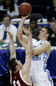 North Carolina's Tyler Hansbrough, right, shoots over Washington State's Aron Baynes during an NCAA East Regional basketball semifinal Thursday, March 27, 2008, in Charlotte, N.C.