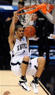 Xavier's Josh Duncan (1) dunks against West Virginia during the second half of an NCAA men's basketball tournament West Regional semifinal, Thursday, March 27, 2008, in Phoenix. Xavier won 79-75.