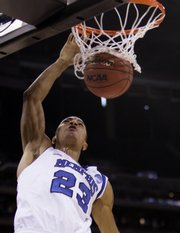Memphis guard Derrick Rose (23) dunks against Texas. Rose led the Tigers to an 85-67 rout Sunday in Houston.