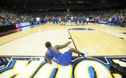 Kansas guard Rodrick Stewart calls attention to his right knee as he lays on the baseline Friday, April 4, 2008 at the Alamo Dome in San Antonio.