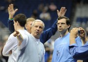 North Carolina coach Roy Williams, left, talks with assistant C.B. McGrath during the start of of the Tar Heels' public practice.