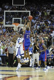 Kansas guard Mario Chalmers elevates for the three-pointer that put the game into overtime. Chalmers connected with 2.1 seconds left to tie it at 63, and the Jayhawks went on to win, 75-68 in overtime, April 7, 2008, in San Antonio.