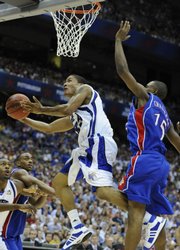 Memphis guard Derrick Rose, left, cuts around Kansas’ Mario Chalmers in this April 7, 2008, file photo at the Alamodome in San Antonio. Memphis was forced on Thursday to vacate all of its victories from the 2007-08 season, where it lost to KU in the national championship. Memphis used an ineligible player, believed to be Rose.