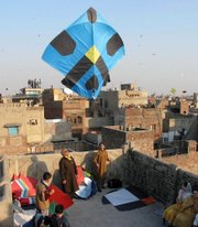 People fly kites to celebrate the spring festival, Basant, in a Feb. 9, 2003, file photo, in Lahore, Pakistan. Pakistan's cultural capital has lost another victim to the country's violence and political turmoil: a centuries-old festival that draws thousands who usher in spring by flying colorful kites.