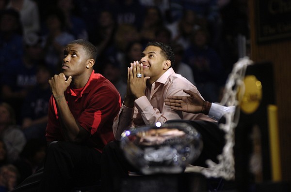 Seniors Rodrick Stewart, left, and Jeremy Case watch a highlight reel during the KU basketball awards ceremony at Allen Fieldhouse. 