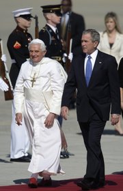 Pope Benedict XVI, left, walks with President Bush, right, during the arrival ceremony Tuesday at Andrews Air Force Base, Md.