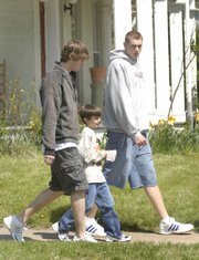 New York Elementary fourth-grader Kai Blosser, 10, paired up with KU men's basketball players Conner Teahan, left, and Cole Aldrich during the LPS On the Move program.