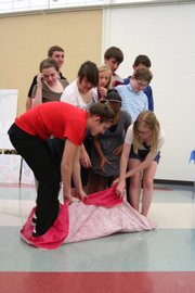 Half of the PIECE Project class performed a final team project during the graduation ceremony Wednesday at Southwest Junior High School. Twenty ninth-graders from Lawrence schools were selected in April 2007 by members of the Leadership Lawrence Program to be in the first-ever youth Peer Involvement Encouraging Community Engagement Project, or PIECE.