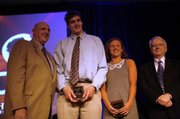 Kansas University seniors Sasha Kaun, second to left, and Terri Schramka, right, accept the Senior Scholar-Athlete awards. At left is athletic director Lew Perkins.