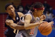 KC Pump N Run's Mike Dixon, right, draws a foul as he brings the ball down the court Friday, May 2, 2008 during a game against Cheyenne- Pump N Run Elite of North Las Vegas during the 9th Annual Jayhawk Invitational at Allen Fieldhouse.